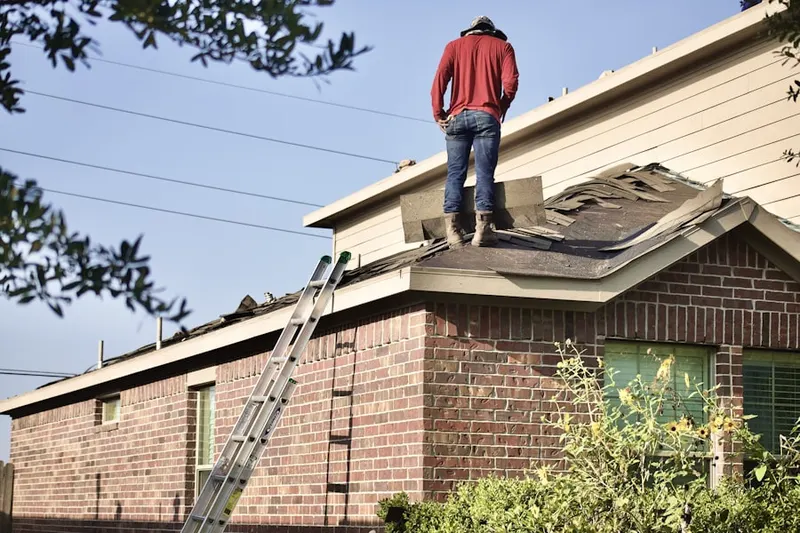 Professional roofer working on a residential roof in Devon